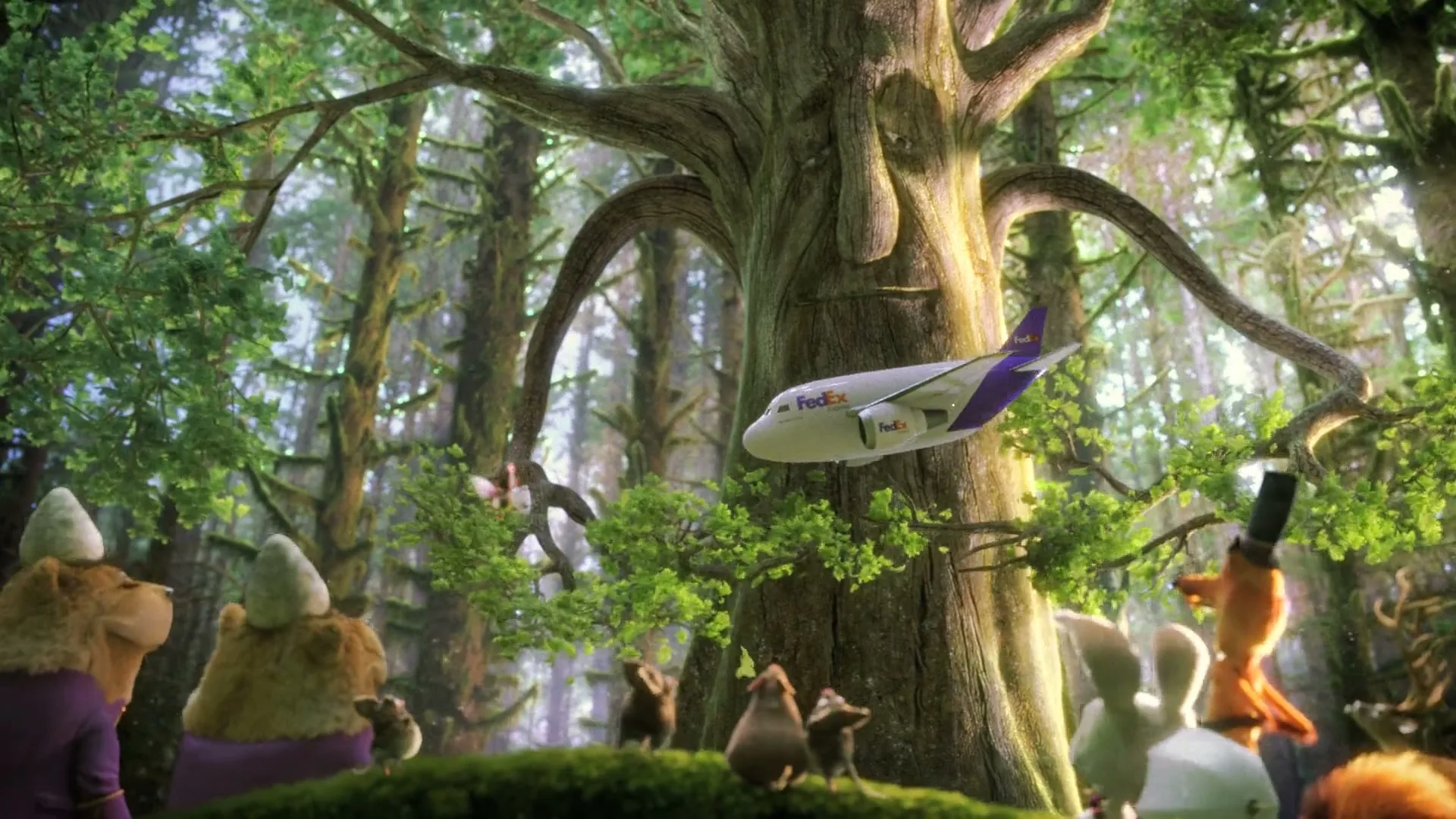 A FedEx plane flies past a large, ancient tree with a face, as various animated forest animals watch in a magical forest.