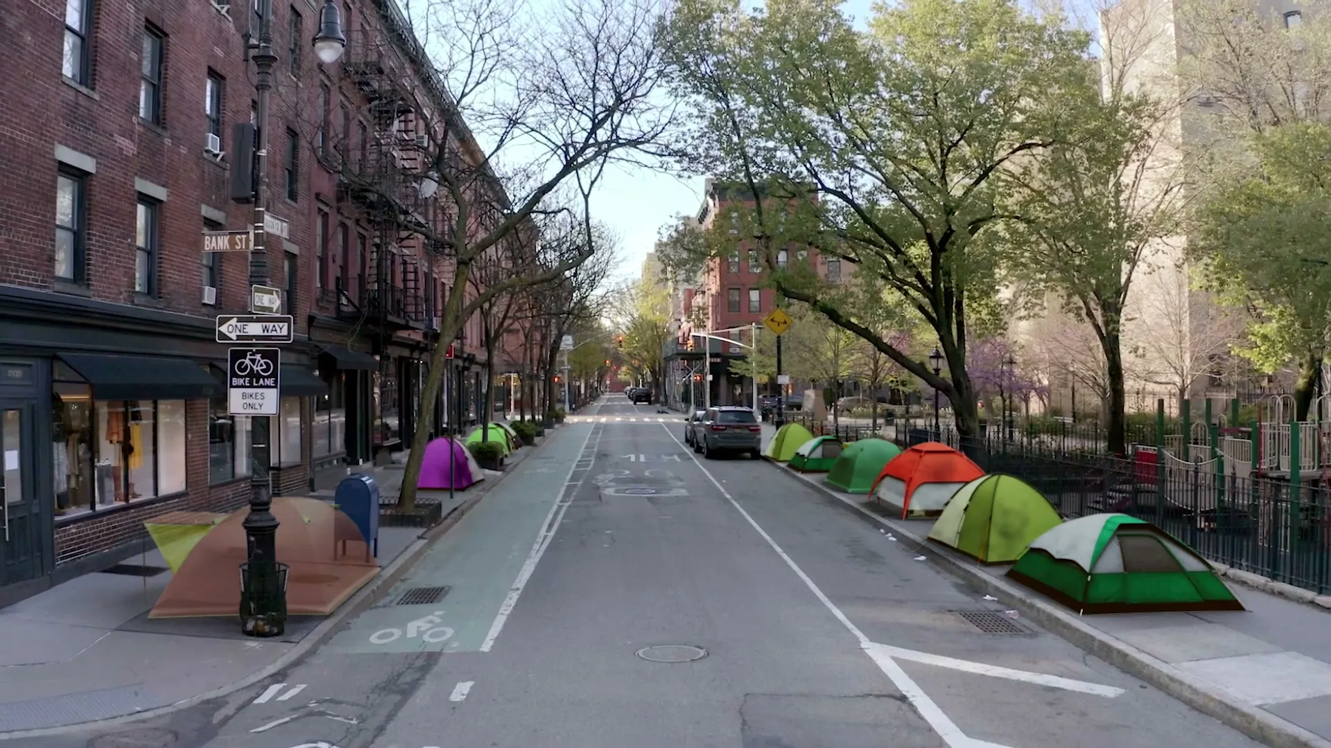 A wide shot of a city street with brick buildings and trees, as colorful tents appear along the sidewalks, symbolizing homelessness.