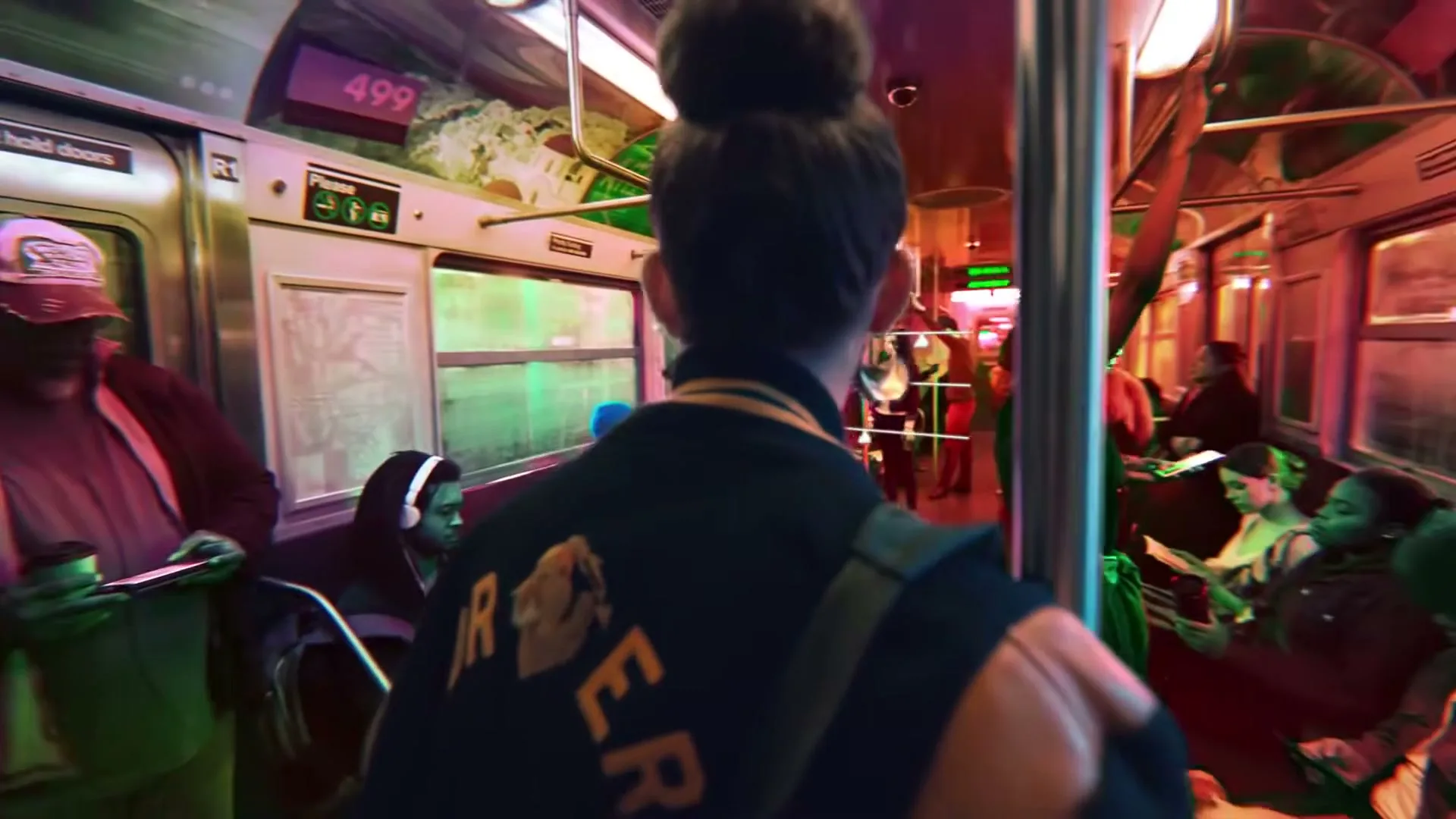A young woman with a high bun and large hoop earrings stands in a subway car, looking around at other passengers in a vibrant, colorful scene.