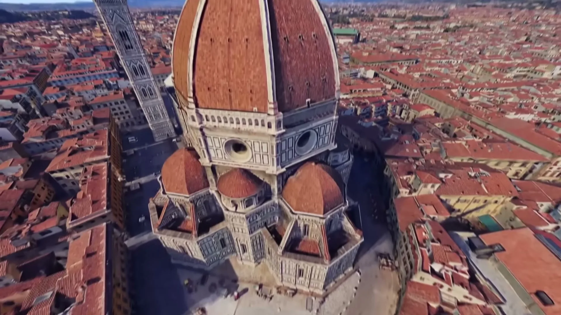 A person wearing a VR headset looks at a virtual globe, then zooms into a detailed view of Florence, Italy, with its iconic Duomo.