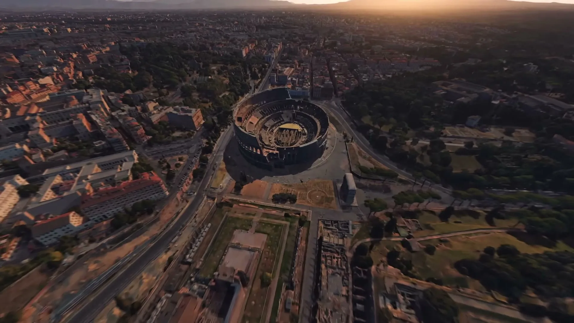An aerial view of the Colosseum in Rome, Italy, surrounded by the city at sunset, rendered in a virtual environment.