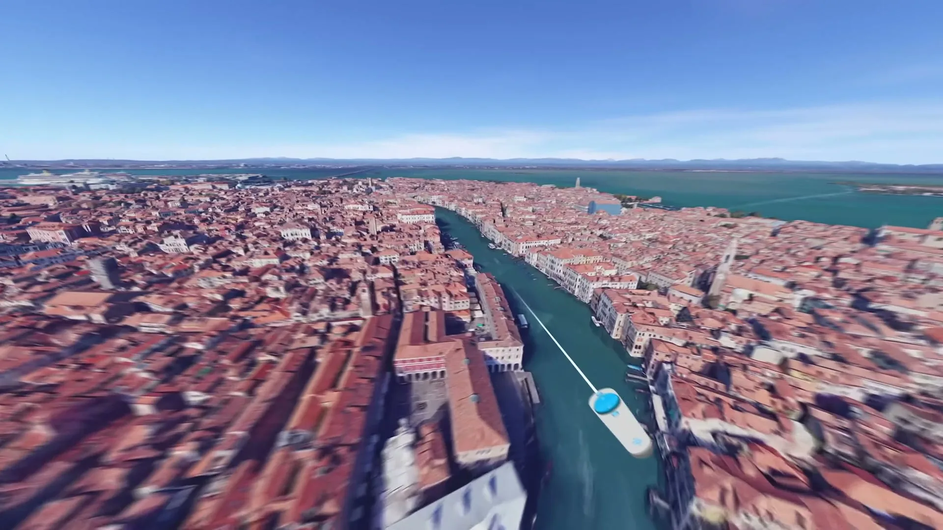 An aerial view of Venice, Italy, with its iconic canals and red-tiled buildings, is shown in a virtual reality tour.