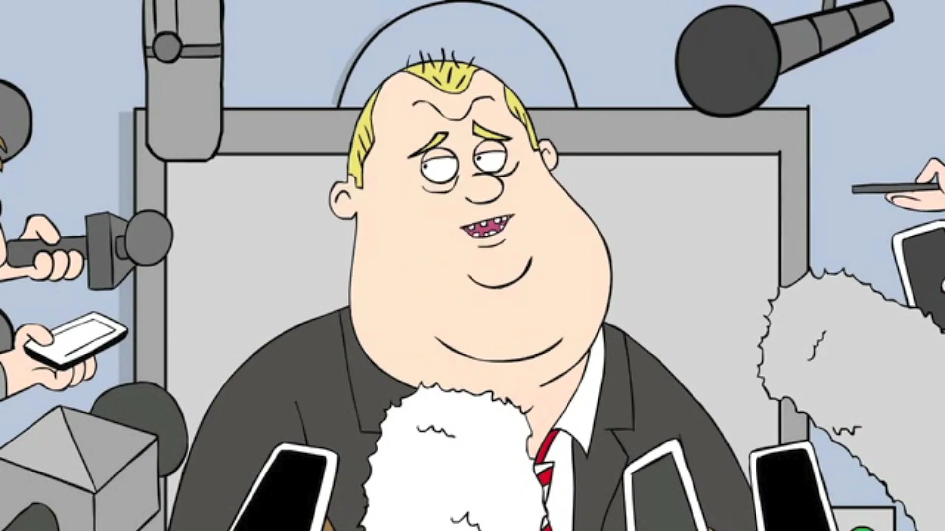 A cartoon man with blonde hair and a suit speaks at a press conference, surrounded by microphones and phones.