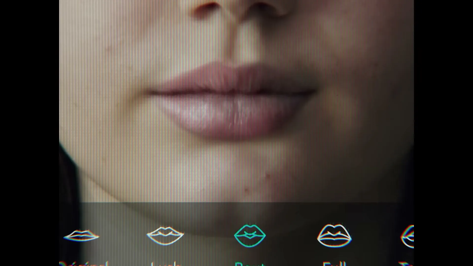 A young woman's face is seen on a phone screen, with a filter being applied to her lips, making them fuller and redder.