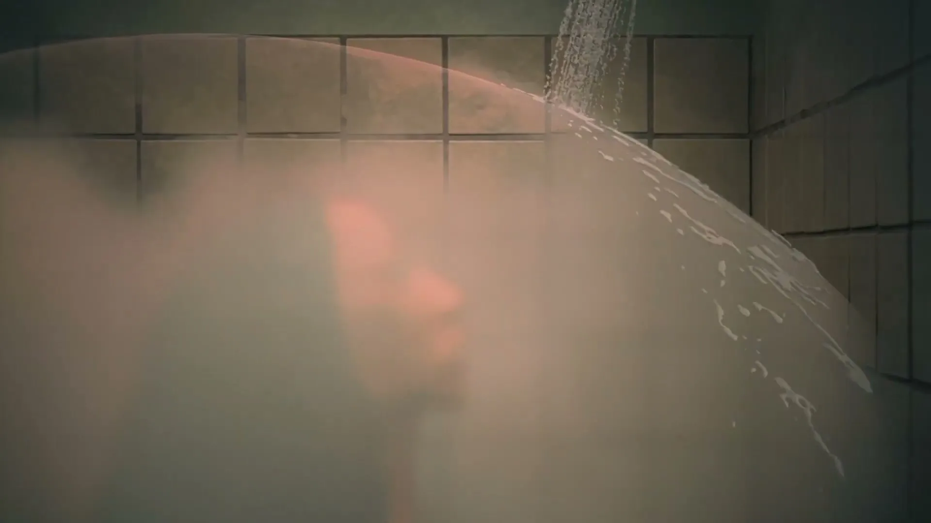 A woman with curly hair looks up at a shower head, as water forms a protective bubble around her in a tiled bathroom.