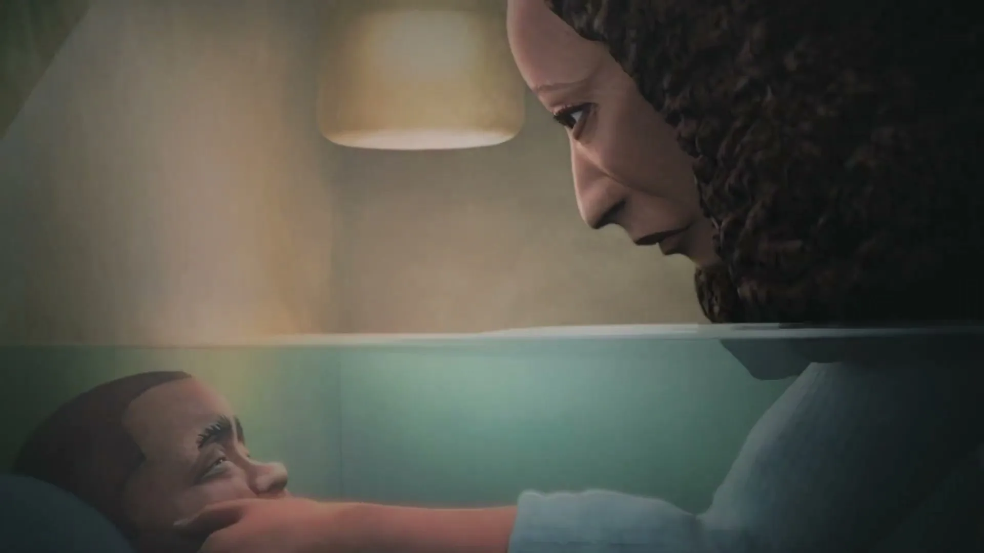 A mother with curly hair leans over her child in a hospital bed, gently touching their face and head, in a dimly lit room.