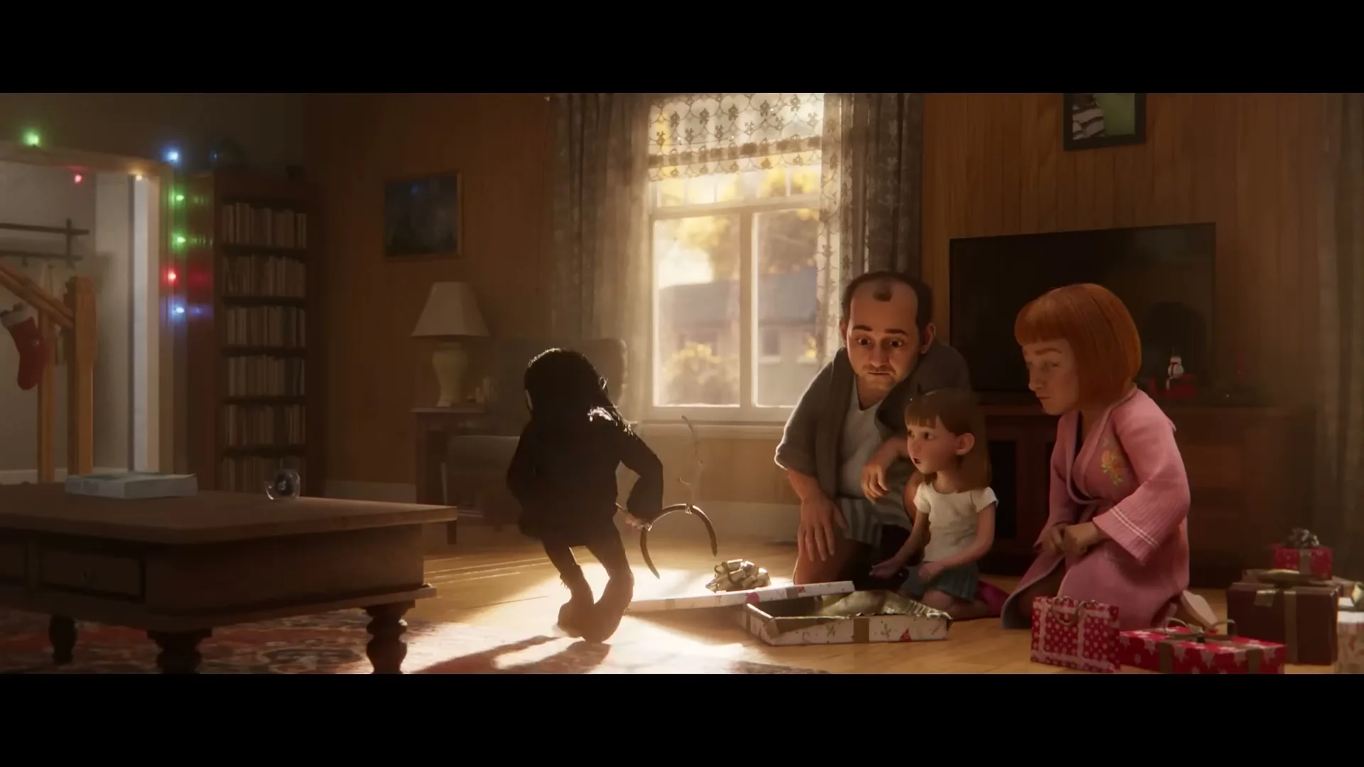 A young girl, dressed in black, kneels on the floor with her family, then stands up and walks away, in a cozy living room.