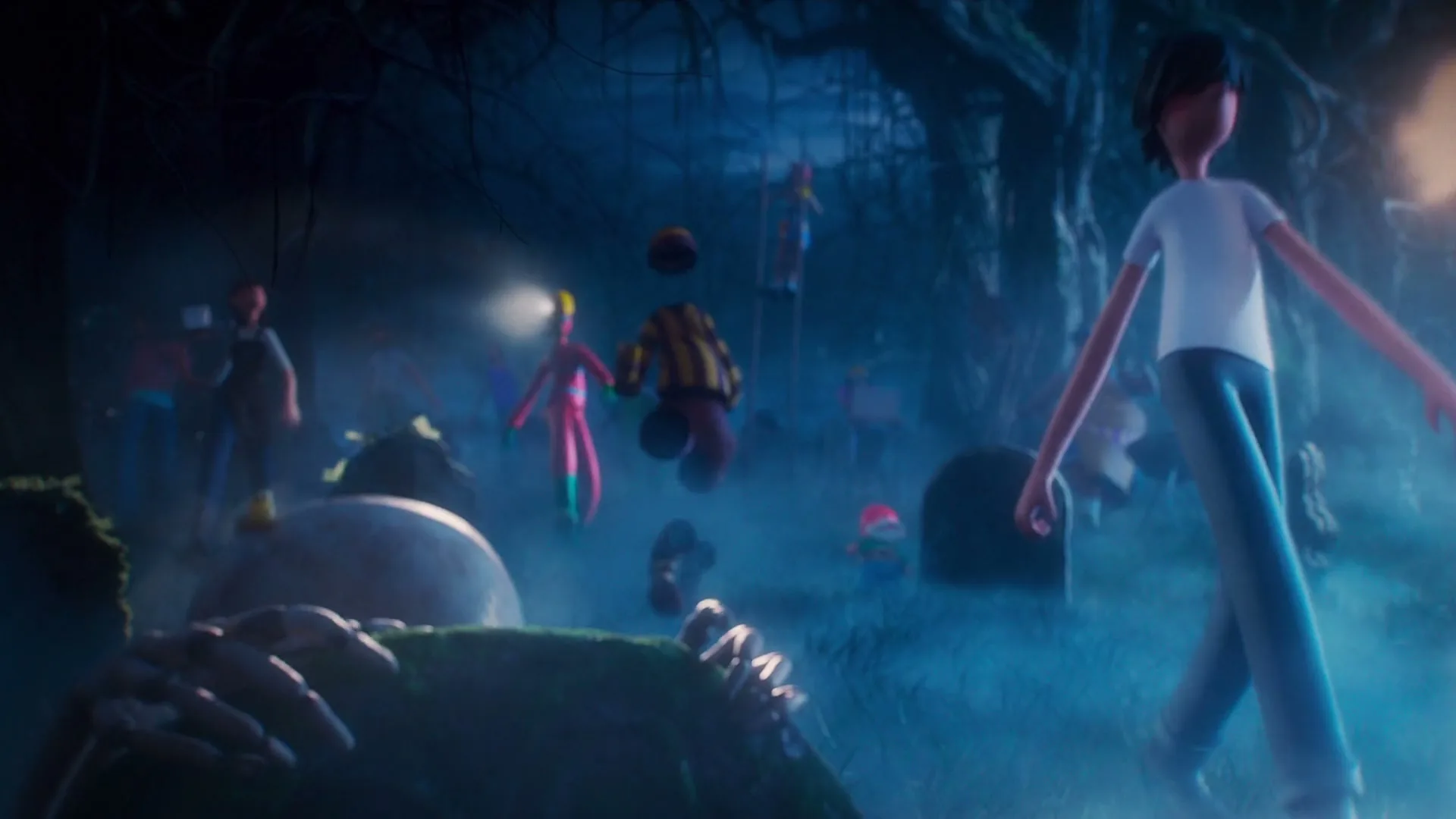 A group of animated characters, including a boy with a lantern, walk through a spooky, foggy graveyard at night, with a skeleton emerging from the ground in the foreground.