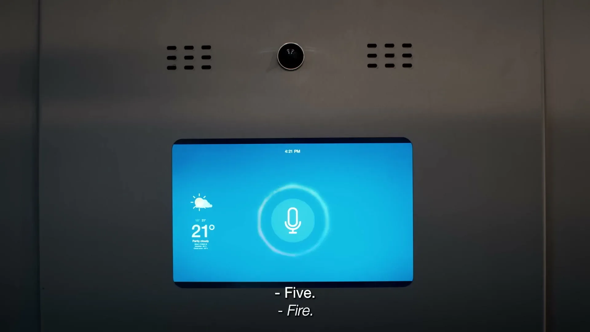 A smart screen in an elevator shows a weather forecast and a microphone icon, with a voice command being processed.