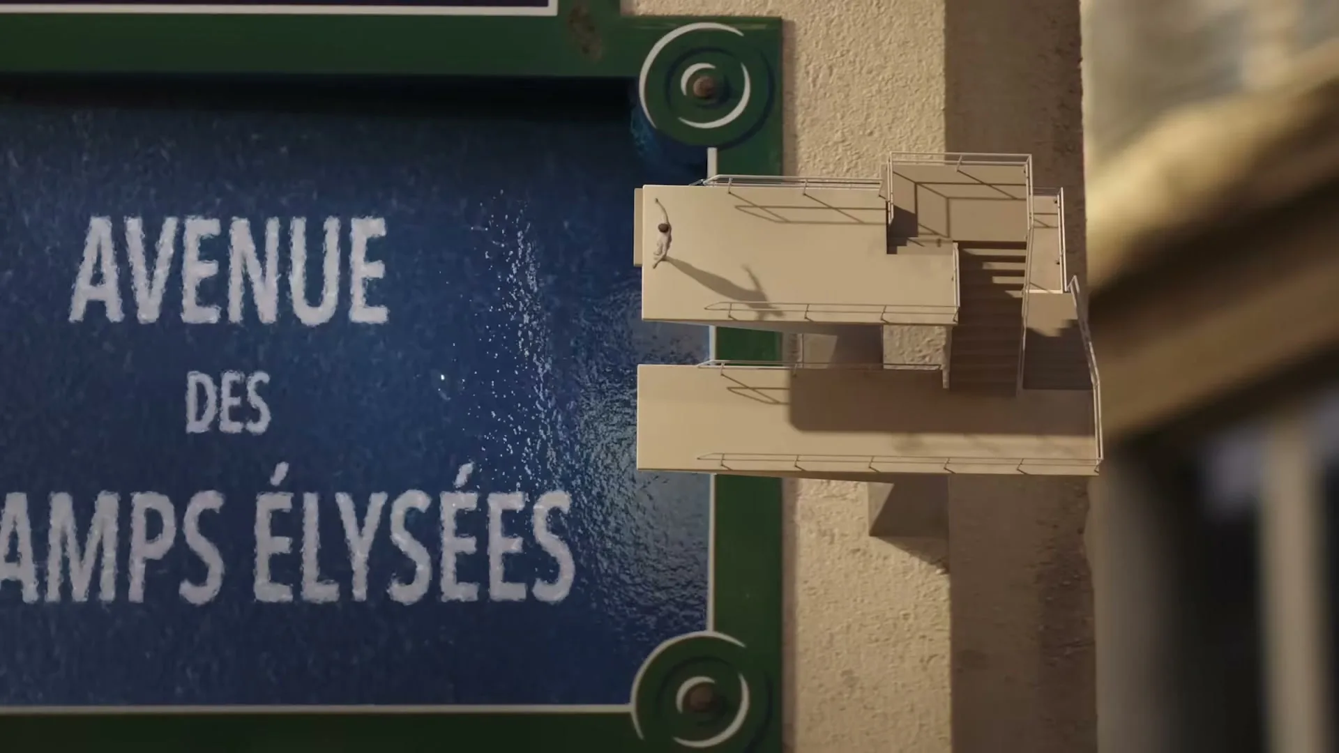 A miniature figure stands on a tiny building next to a street sign for "Avenue des Champs-Élysées" in Paris.
