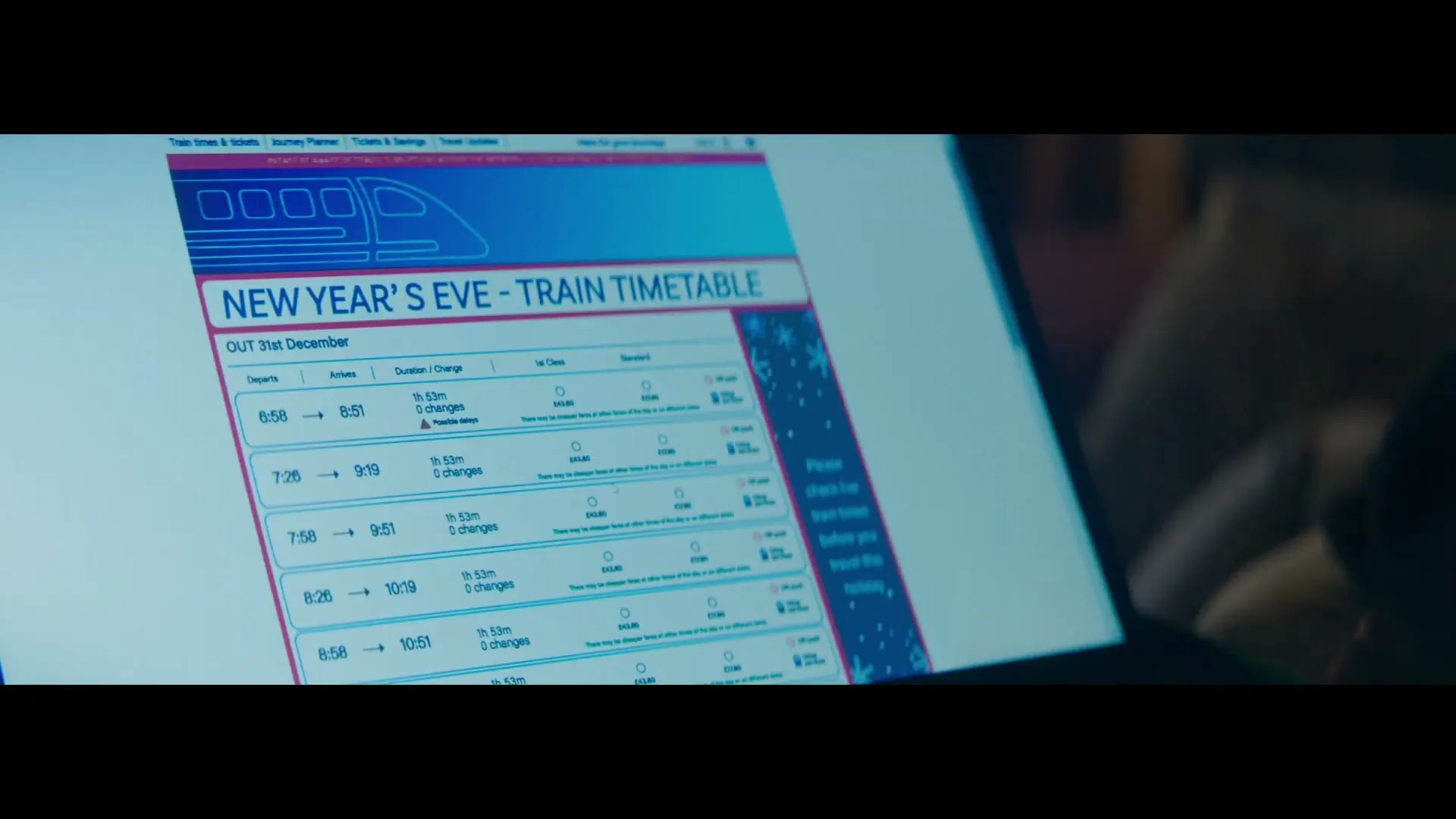 A close-up shot shows a person's hands scrolling through a "New Year's Eve - Train Timetable" on a laptop screen, displaying various train departure and arrival times.