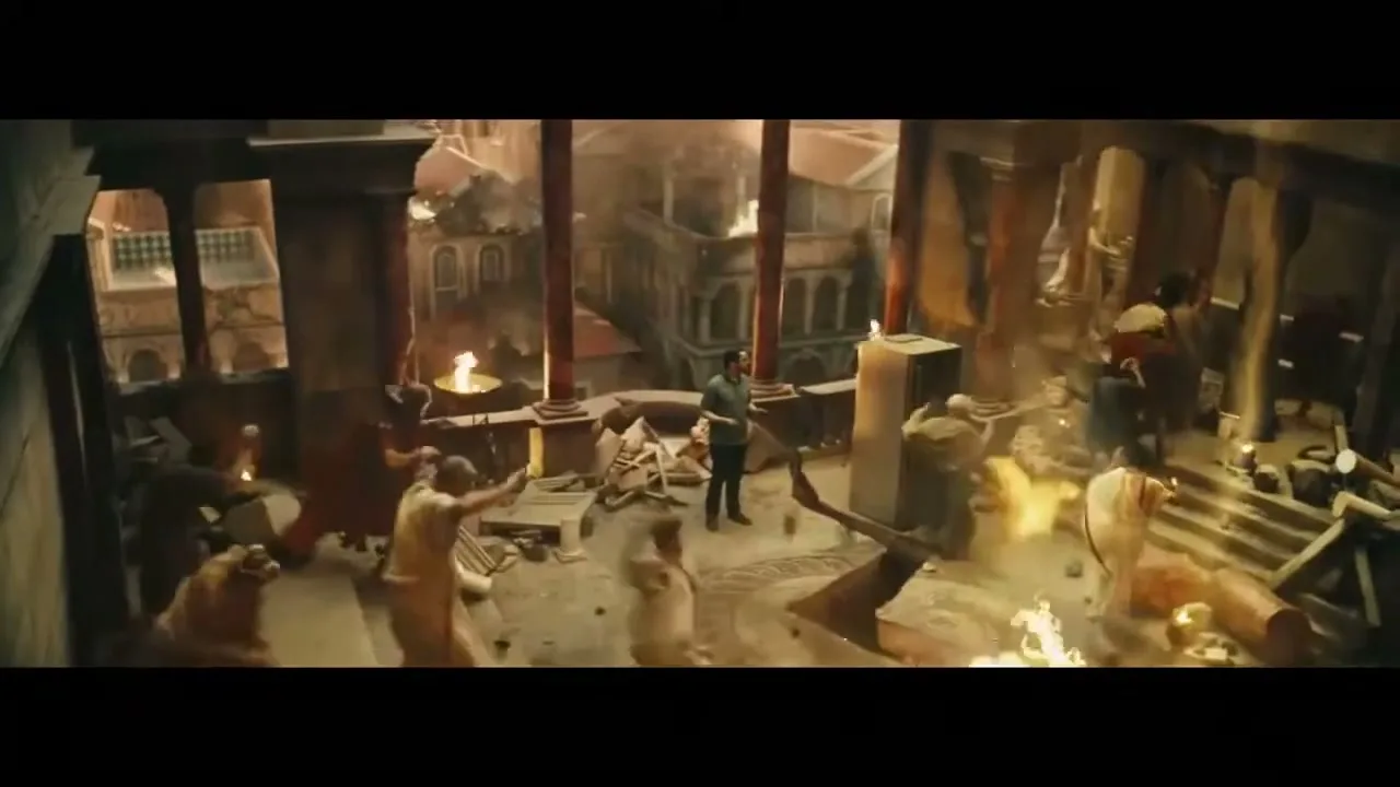 A man in modern clothes stands calmly amidst chaos and fire in an ancient Roman-style building, while people in period attire panic around him.