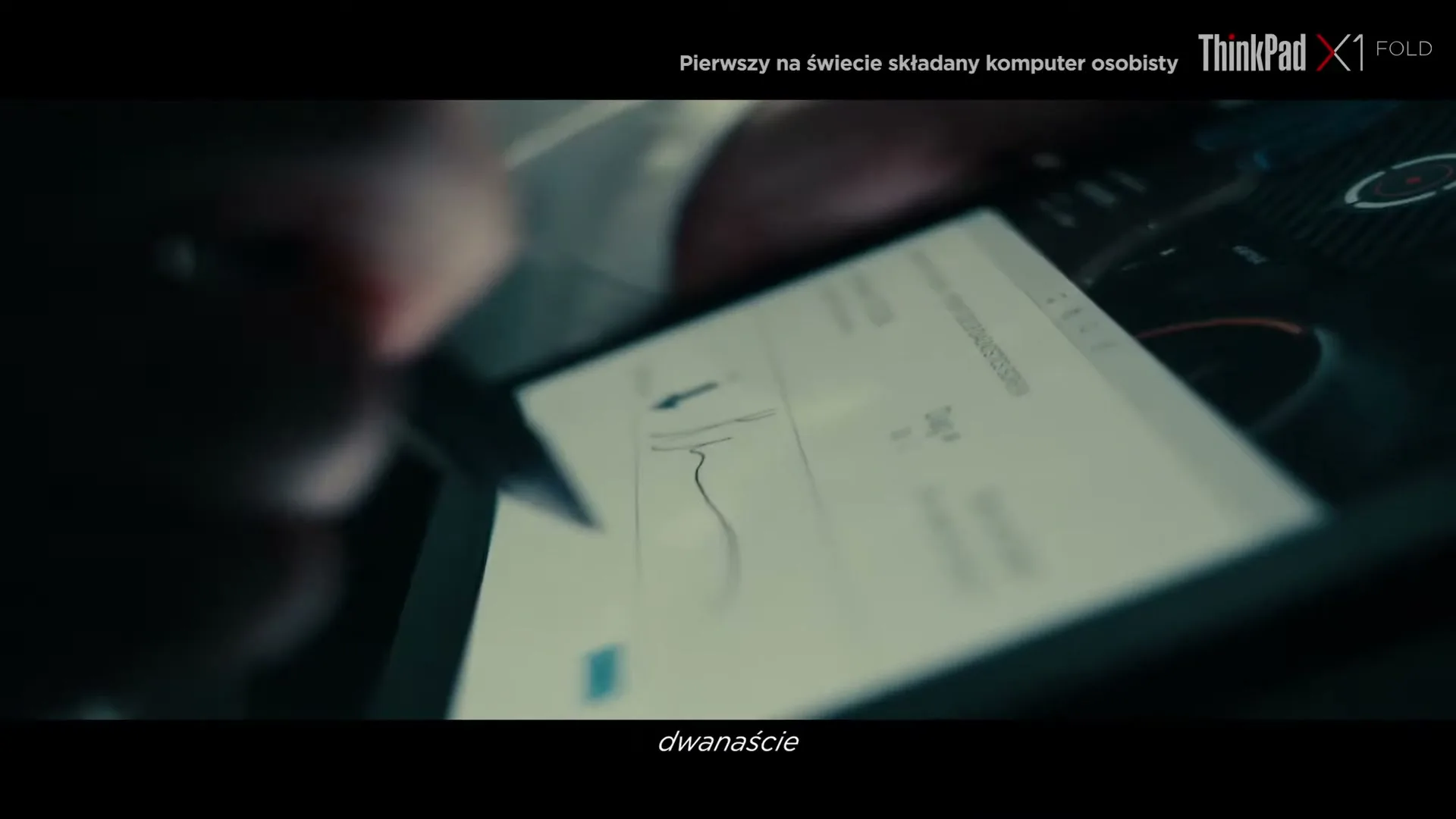 A person's hand uses a stylus to draw on a Lenovo ThinkPad X1 Fold screen in a close-up shot, with the screen displaying data.