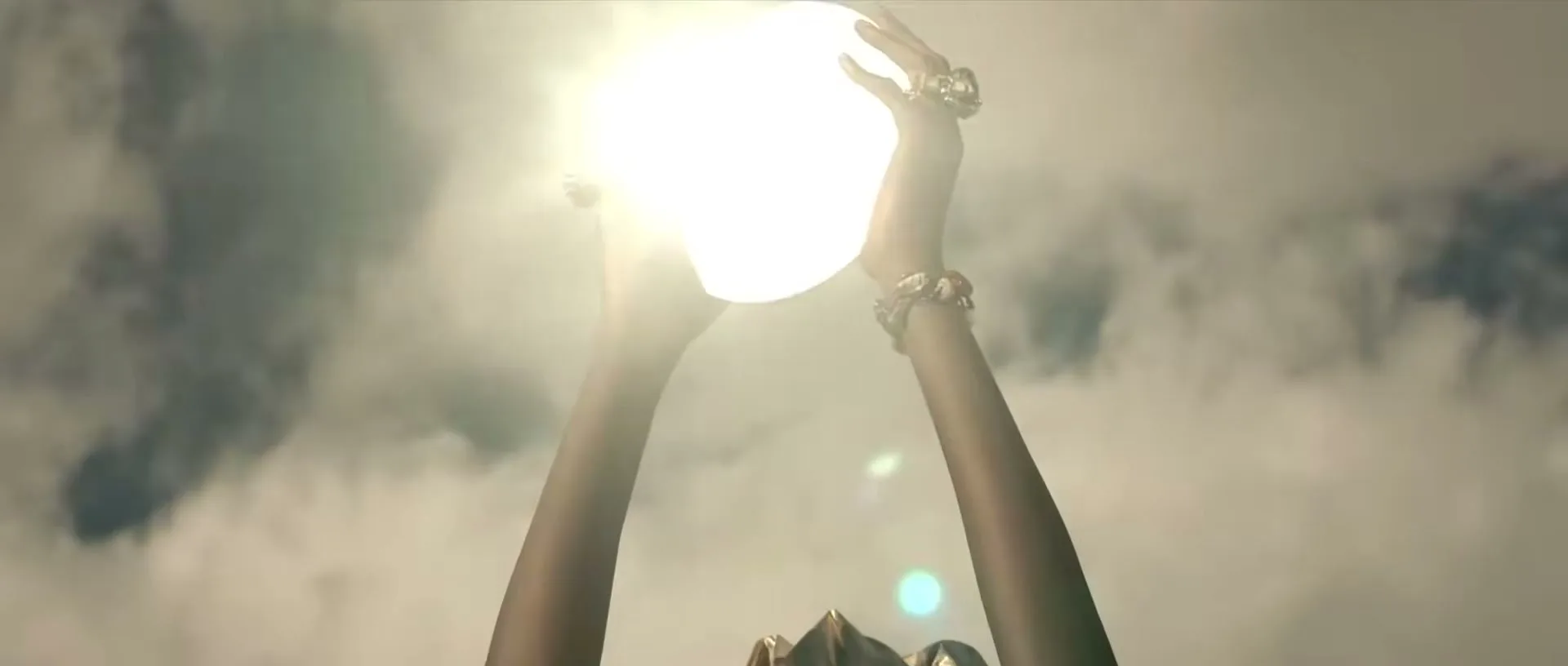 A person with dark skin holds a glowing orb above their head against a cloudy sky, wearing rings and bracelets.
