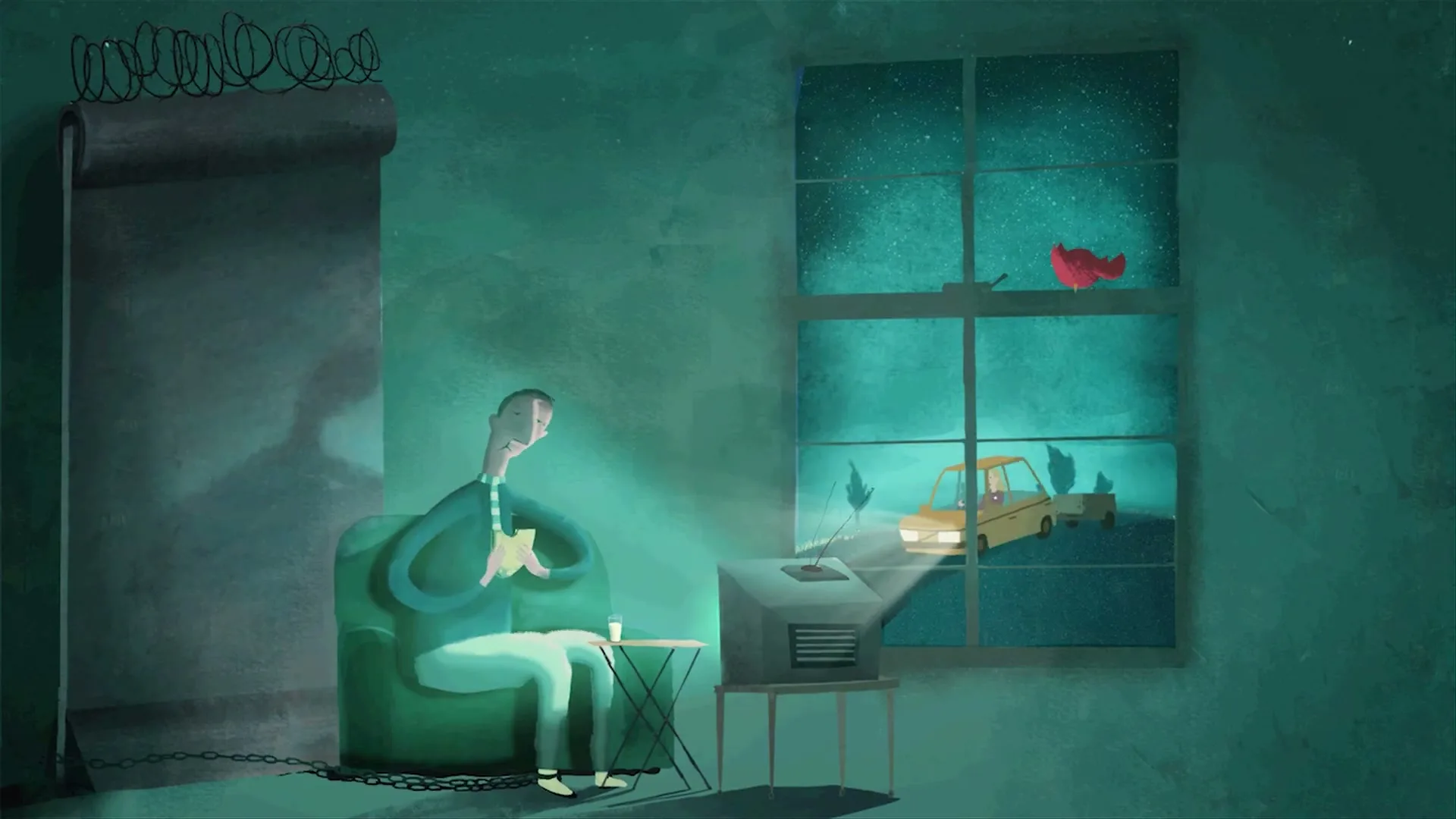 A man sits chained to a chair, watching a car drive by outside his window on a small TV, in a dark room.
