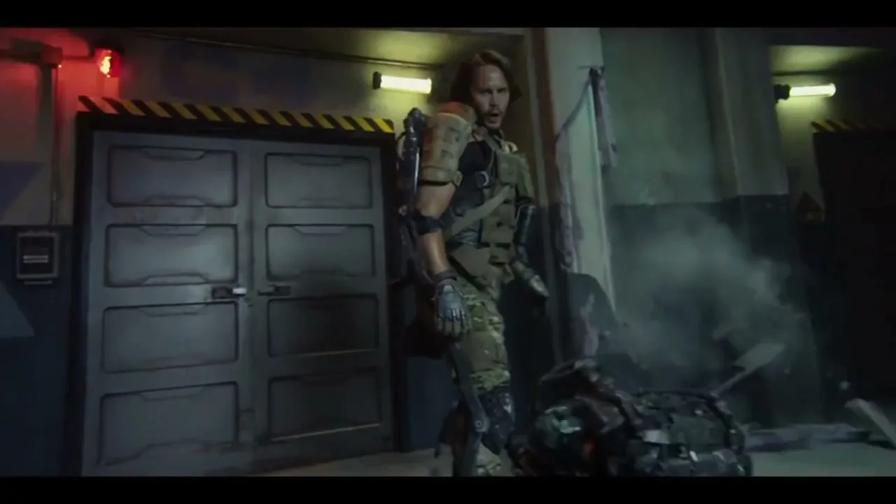 A man in a futuristic military suit fights another soldier, then opens a case with advanced weaponry inside a dimly lit bunker.