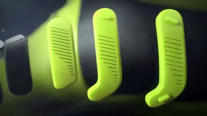 A close-up shot reveals the bright yellow studs of a Nike CTR360 football boot, highlighting its innovative design and texture.