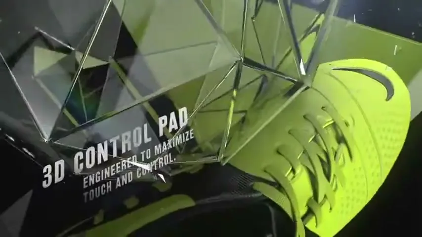 A bright green Nike soccer cleat is shown in a stylized CG environment with text describing its "3D Control Pad" feature.