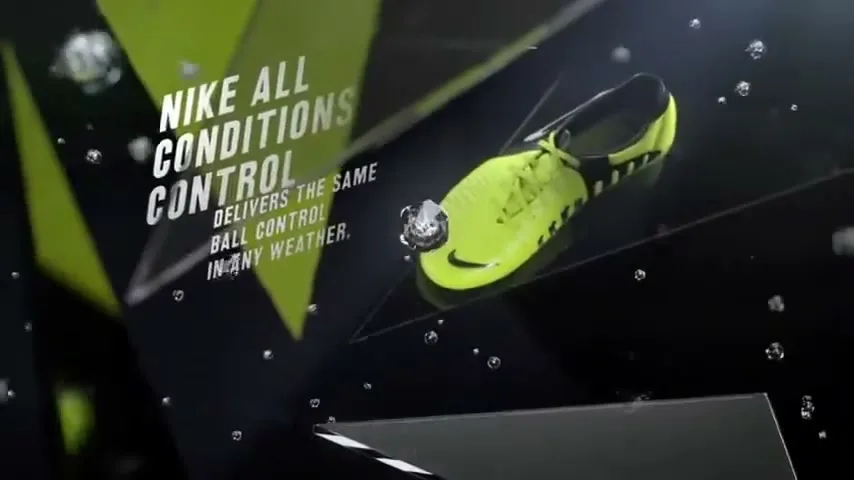 A bright yellow Nike soccer cleat is shown in a dark, abstract CG environment with geometric shapes and water droplets.