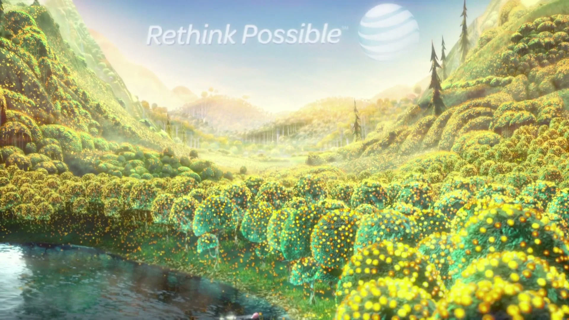 A wide shot of a fantastical valley with glowing trees and a river, with the AT&T logo and tagline appearing on screen.