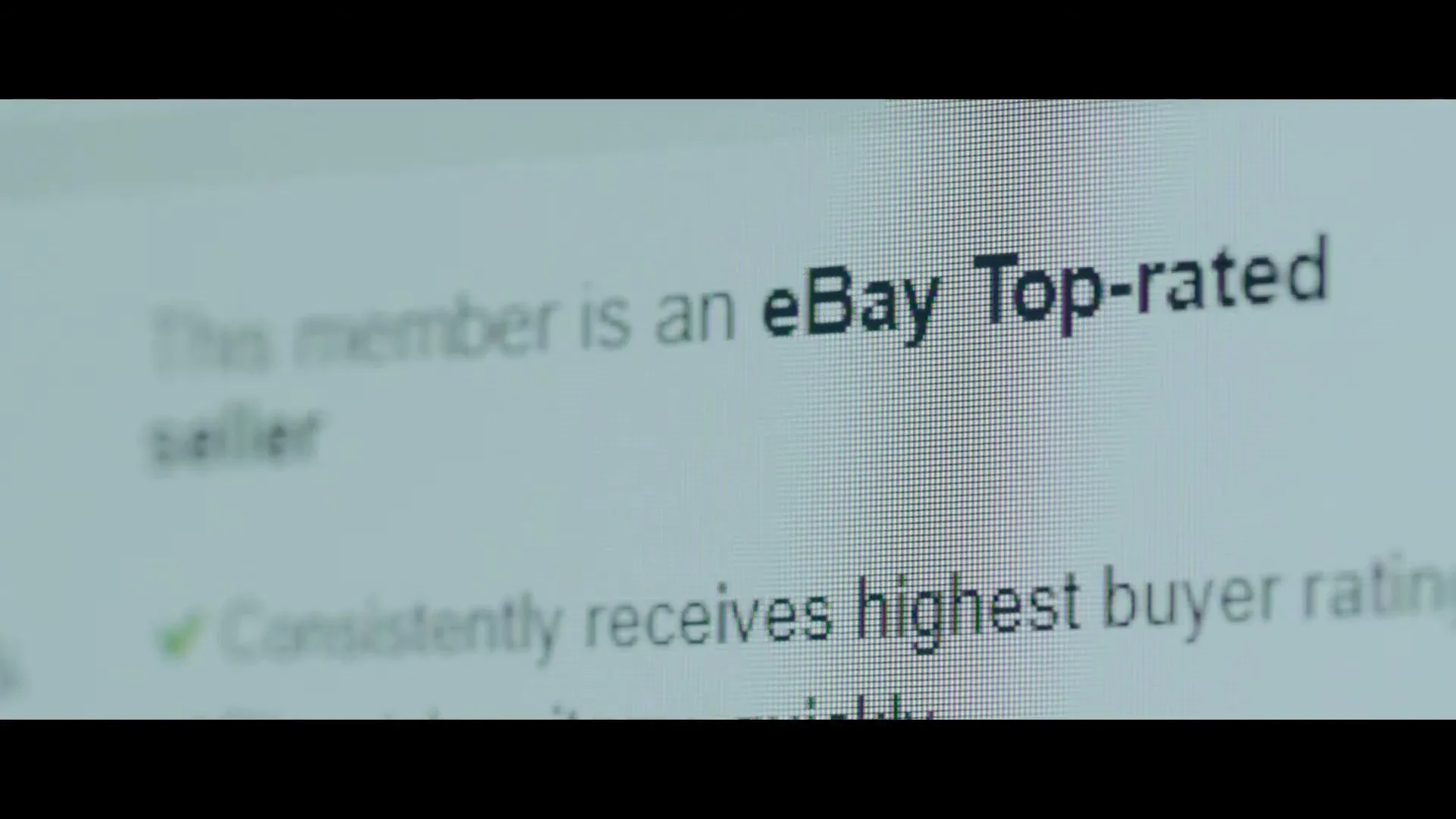 A close-up shot of a computer screen displays text and star ratings, indicating an eBay Top-rated seller and their average rating.