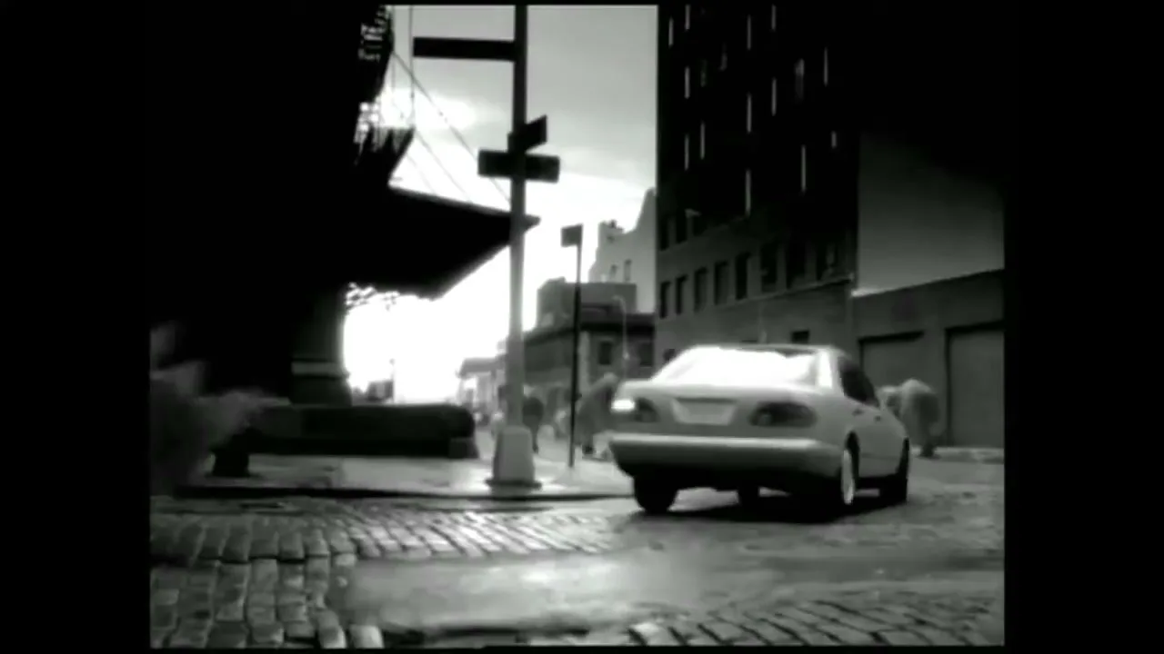 A Mercedes-Benz car drives through a city street as rhinos run past it in black and white.