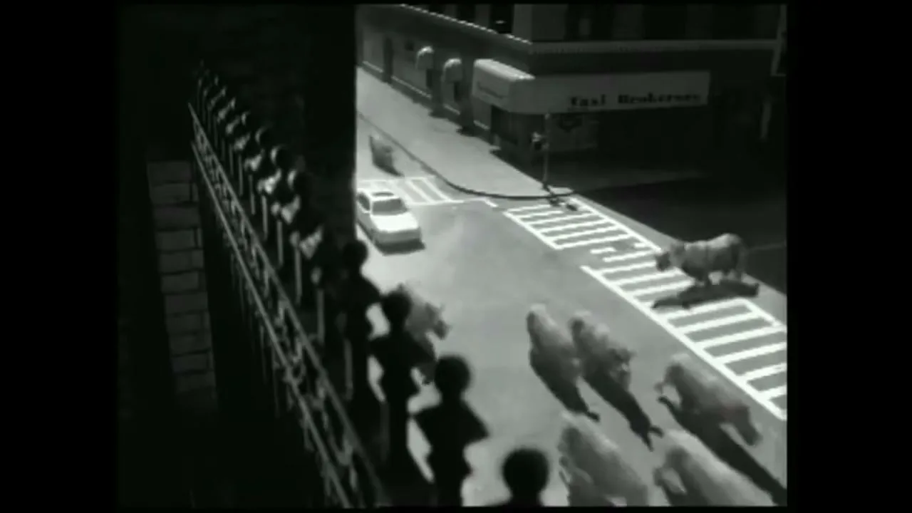 A white car drives through a city street as a herd of rhinos stampedes across a crosswalk, observed by silhouetted people on a bridge.