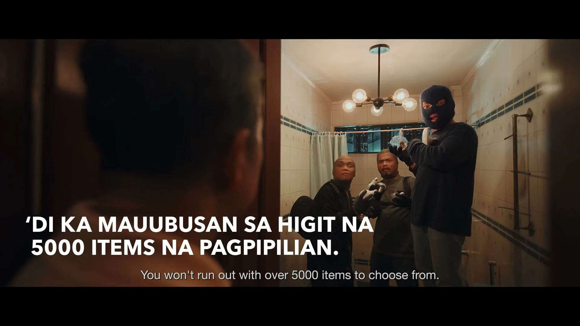 Three male burglars, one wearing a ski mask, stand in a bathroom, looking surprised as they are caught in the act.