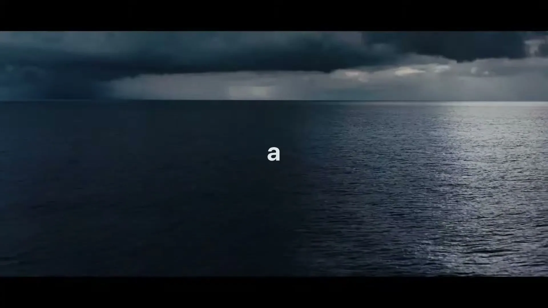 The words "911" and then "a" and then "hang" appear on screen over a wide shot of a dark ocean under a stormy sky.