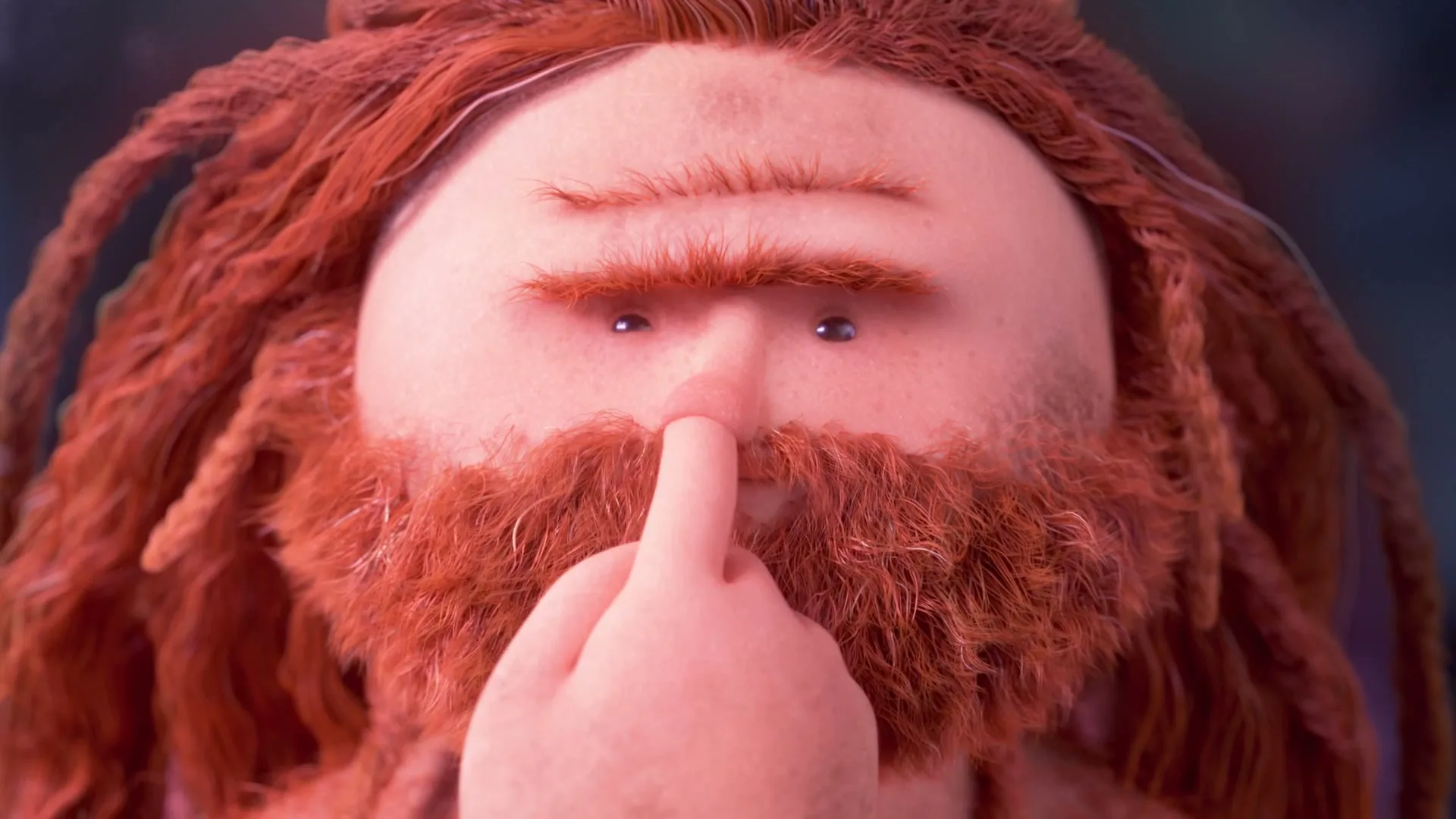 A stop-motion animated man with a large red beard and dreadlocks puts his finger to his nose, looking directly at the camera.