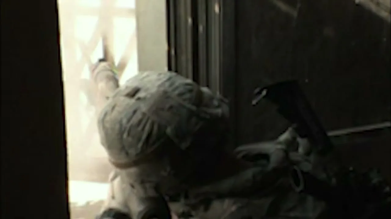 A soldier in camouflage gear aims a rifle through a window, with bright light coming from outside, in a dark interior setting.