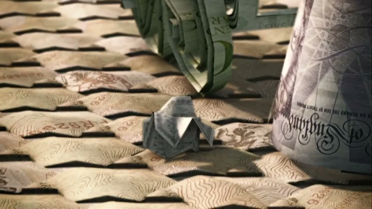 A small origami figure made of money sits on a surface of money, while a larger money-made object looms in the background.