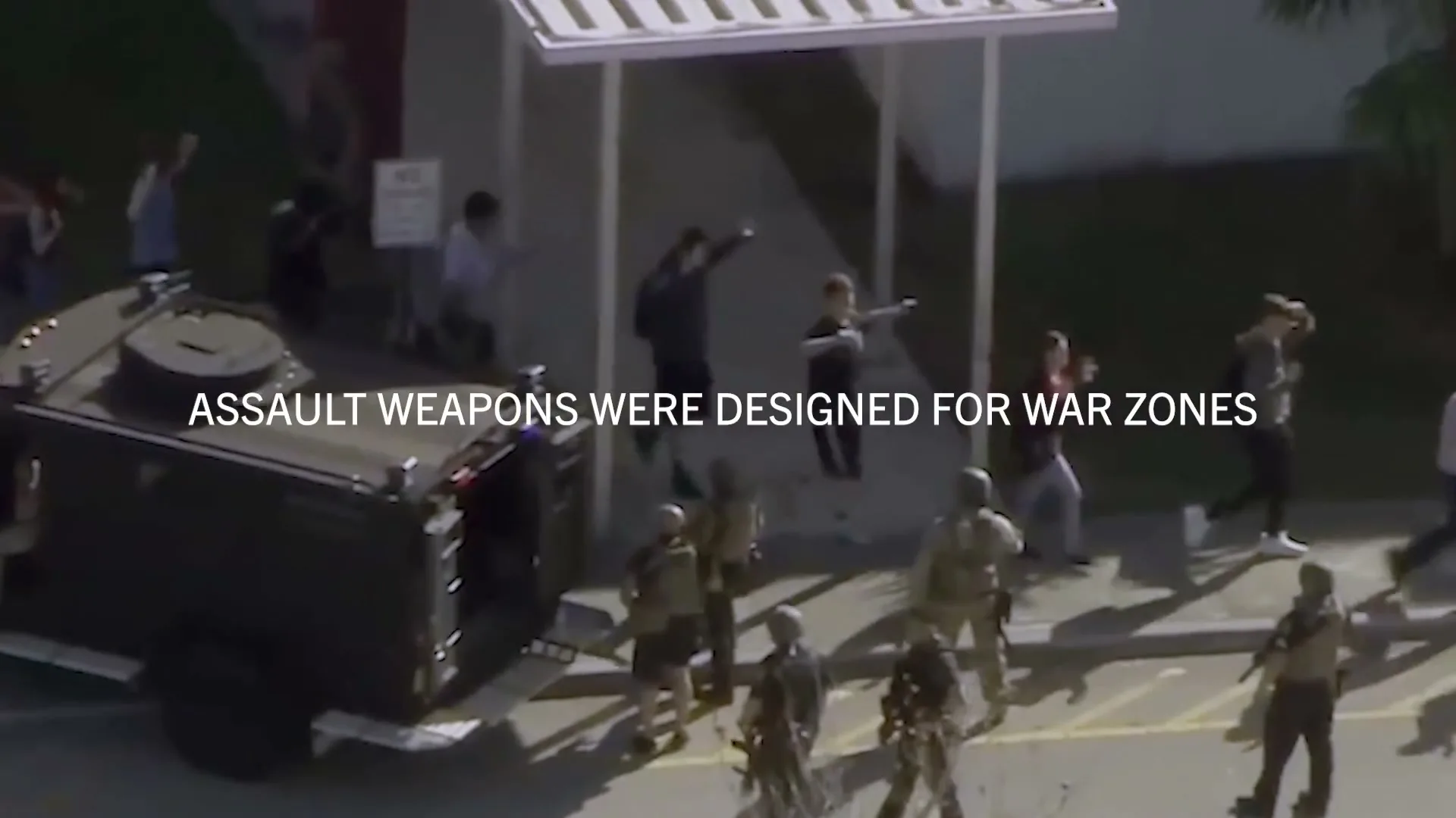 An aerial view shows a SWAT team and armored vehicle on a school campus, with students evacuating and raising their hands in surrender.