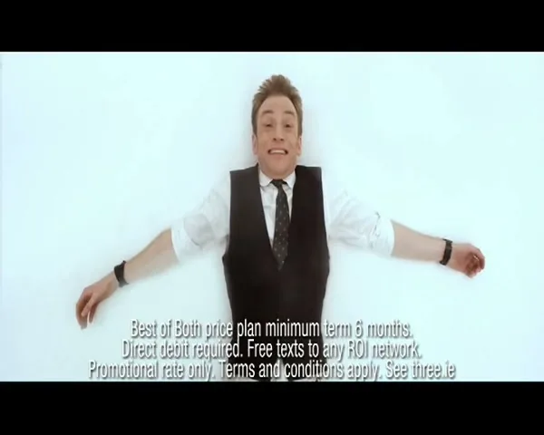 A man in a white shirt and black vest falls backward onto a white surface, spreading his arms and legs, with legal text at the bottom.