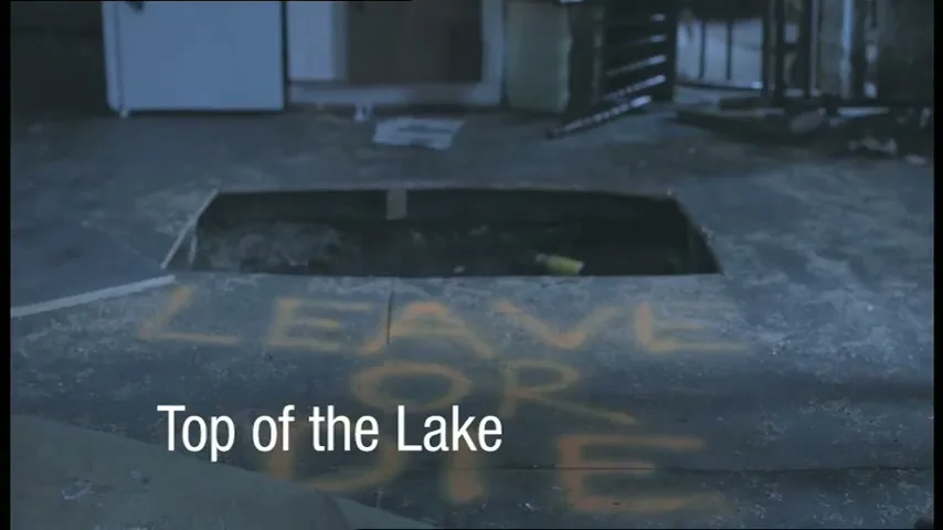 A wide shot shows a dark, abandoned room with a rectangular hole in the floor and the words "LEAVE OR DIE" spray-painted on the ground.