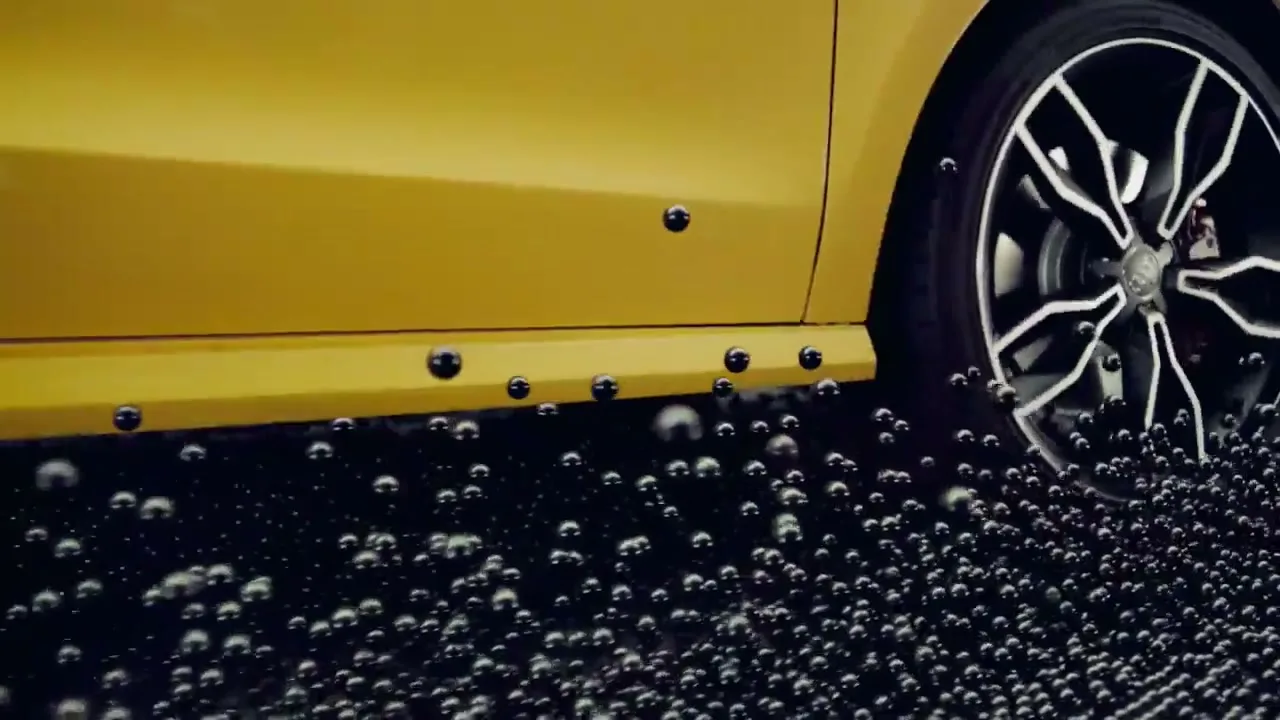 A yellow car's side and wheel are shown as small black spheres bounce off its lower body, creating a dynamic visual effect.