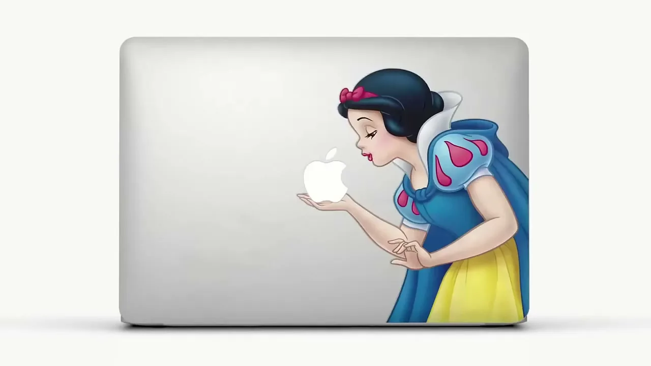 A sticker of Snow White is placed on the back of a silver laptop, holding the glowing Apple logo like an apple, against a white background.