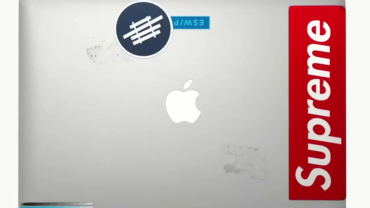 A silver laptop with an Apple logo is shown from above, as various stickers rapidly appear and cover its surface.