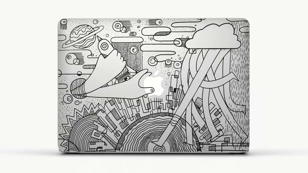 A white MacBook with a black and white line art sticker design featuring hands, planets, and cityscapes is shown against a plain white background.