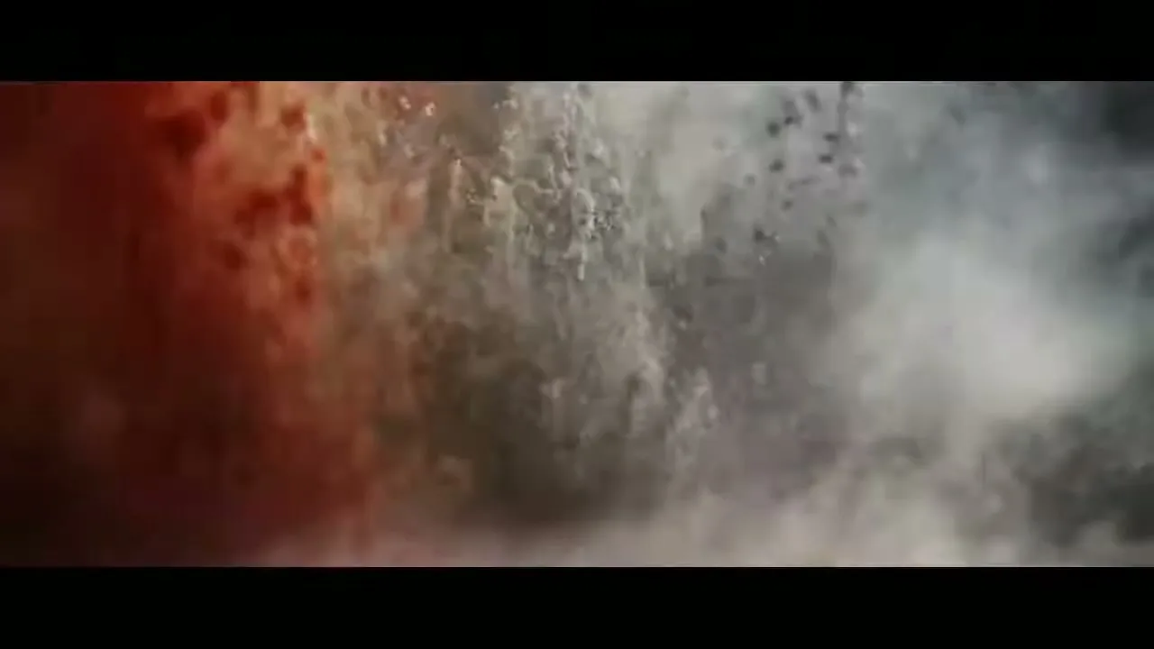 A dynamic, abstract shot of water and particles swirling and mixing, creating a chaotic and energetic visual.
