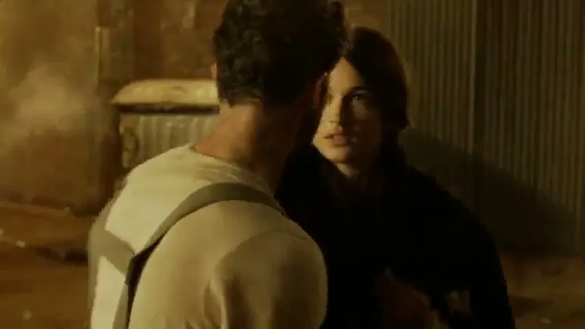 A heroic man carries a woman out of a burning building, then they share a tender moment in a smoky alleyway.
