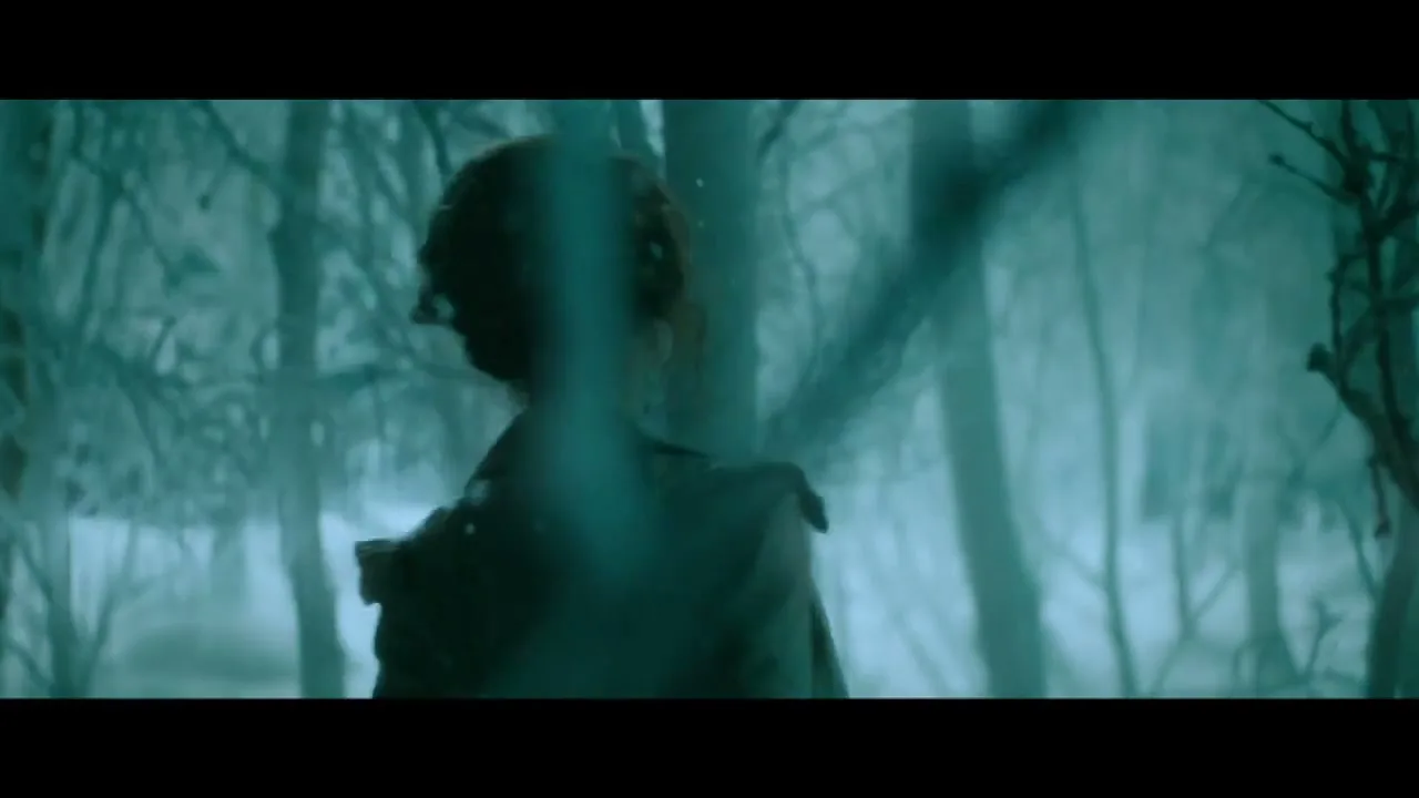 Three women in period costumes walk through a dark, snowy forest at night, looking around with curious expressions.