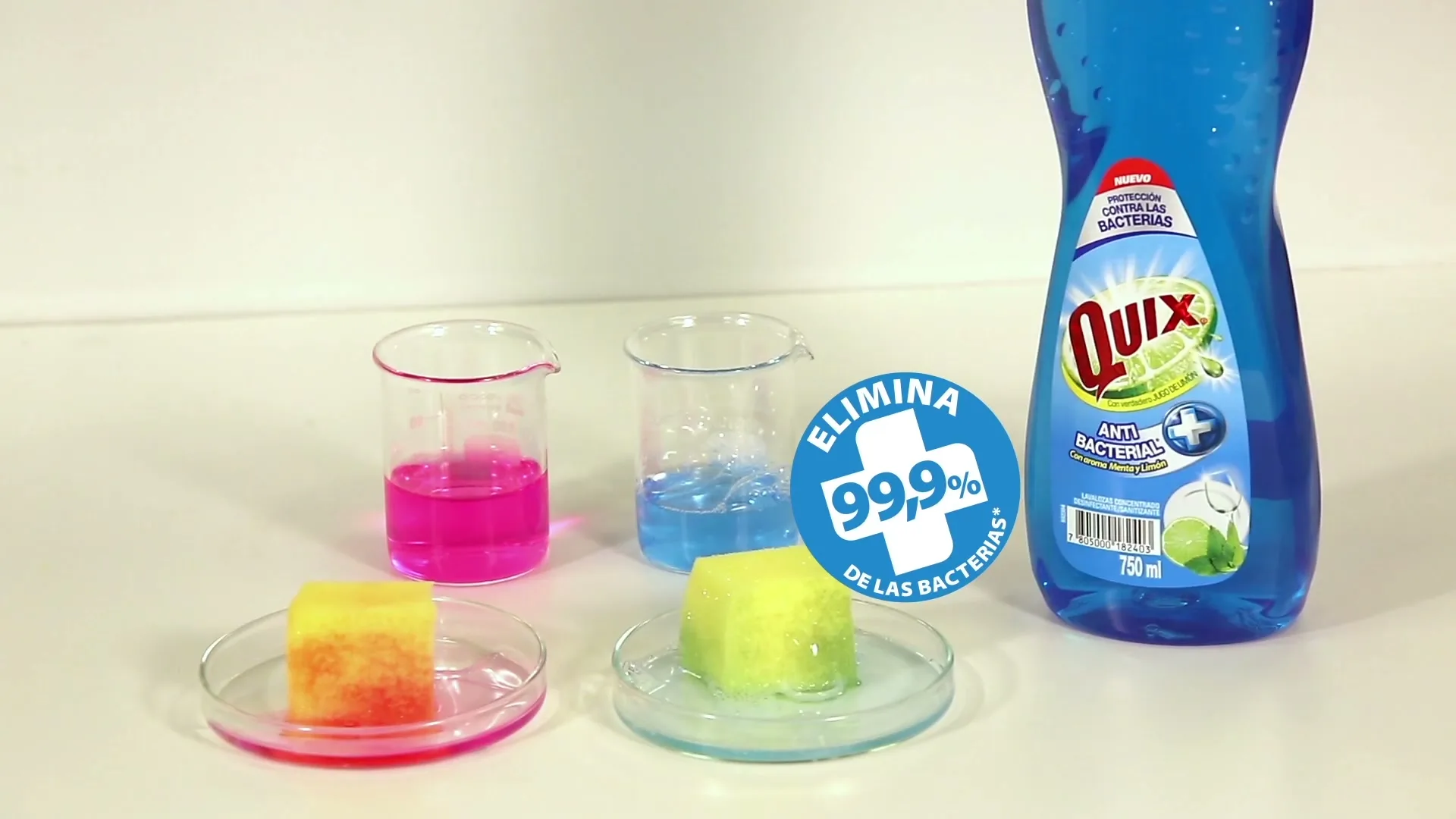 A close-up shot shows two hands pointing at two beakers with colored liquid and two sponges on petri dishes, demonstrating the product's antibacterial properties.