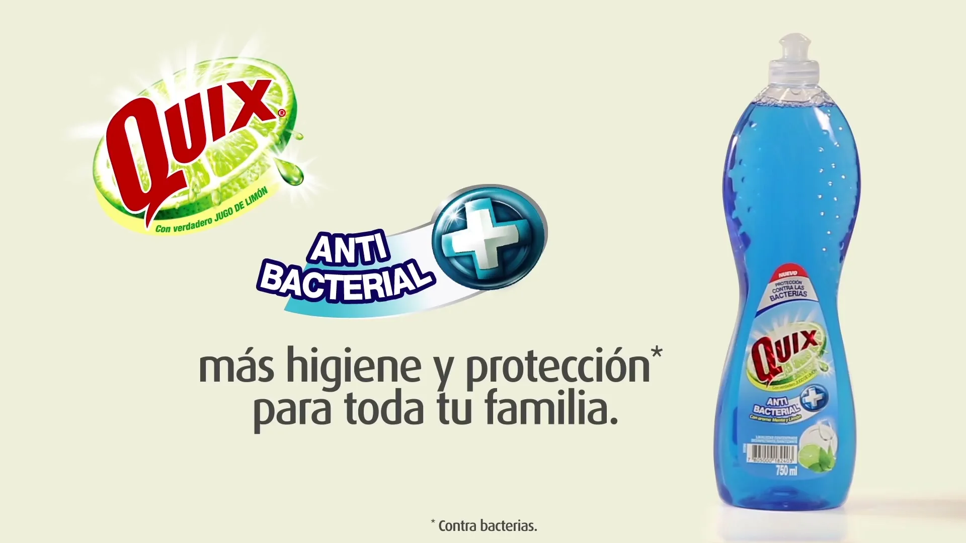 A blue bottle of Quix dish soap with a label showing "Anti Bacterial" and a lime, stands on a white surface with text and logo appearing on the left.