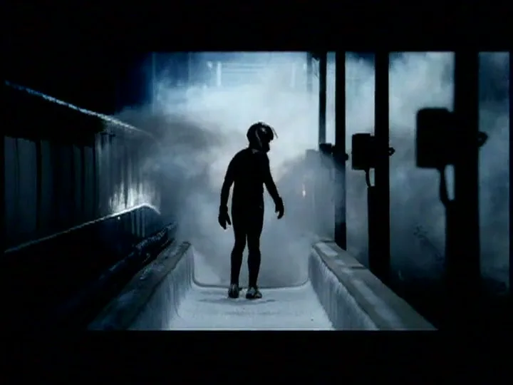 A lone bobsledder, silhouetted and wearing a helmet, stands in a smoky, icy bobsled track, looking around with a determined expression.