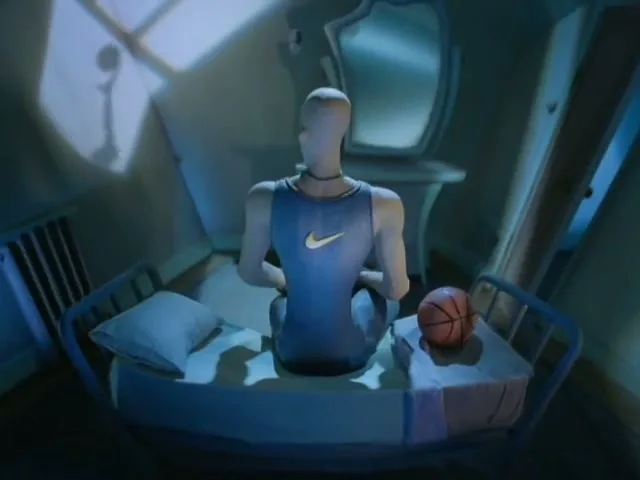 A stop-motion animated mannequin wearing a blue Nike tank top sits on a bed next to a basketball in a dimly lit attic room.