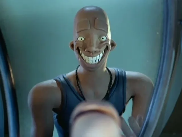 A bald, animated character in a blue tank top looks into a mirror, trying on different exaggerated facial expressions in a blue room.