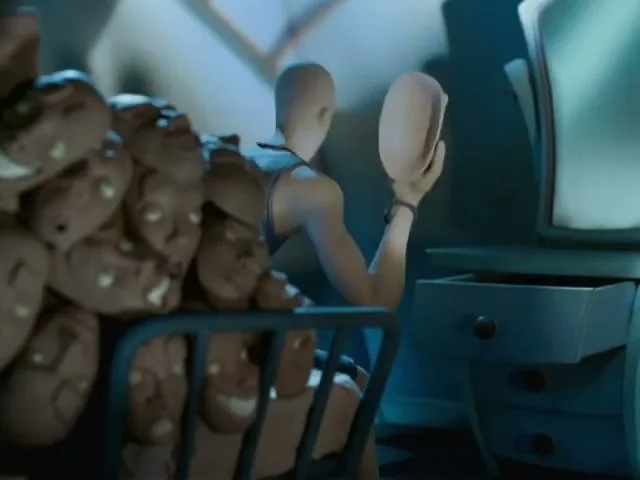A claymation figure with no face holds up a blank face mask, then discards it, in a dimly lit room with a pile of face masks.