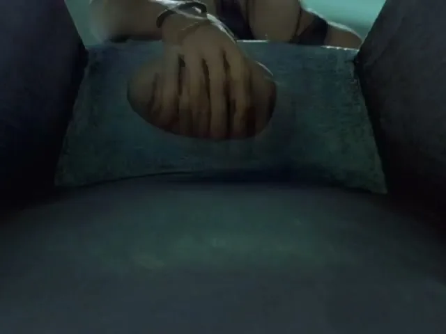 A hand reaches into a box and picks up a bald head, then puts it on.