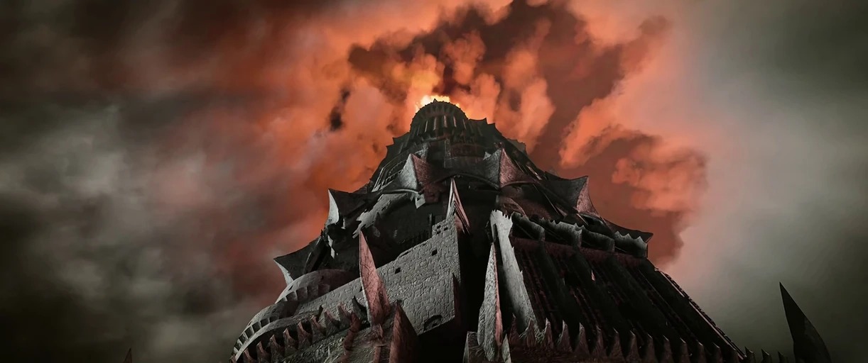 A massive dark stone fortress tower with jagged spikes rises into a storm sky. Heavy orange clouds swirl around the peak of the tower which emits an intense fire.